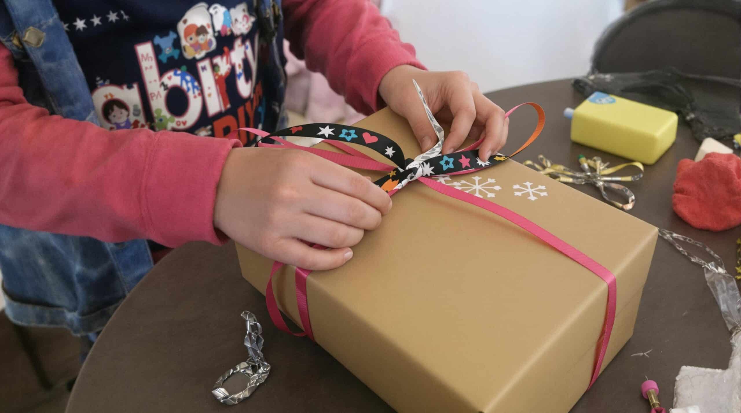 A child wraps a homemade gift