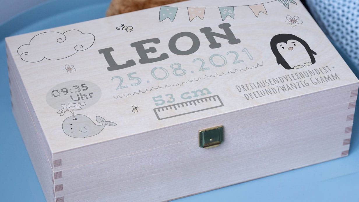 A wooden box with individual embossing and baby motifs.