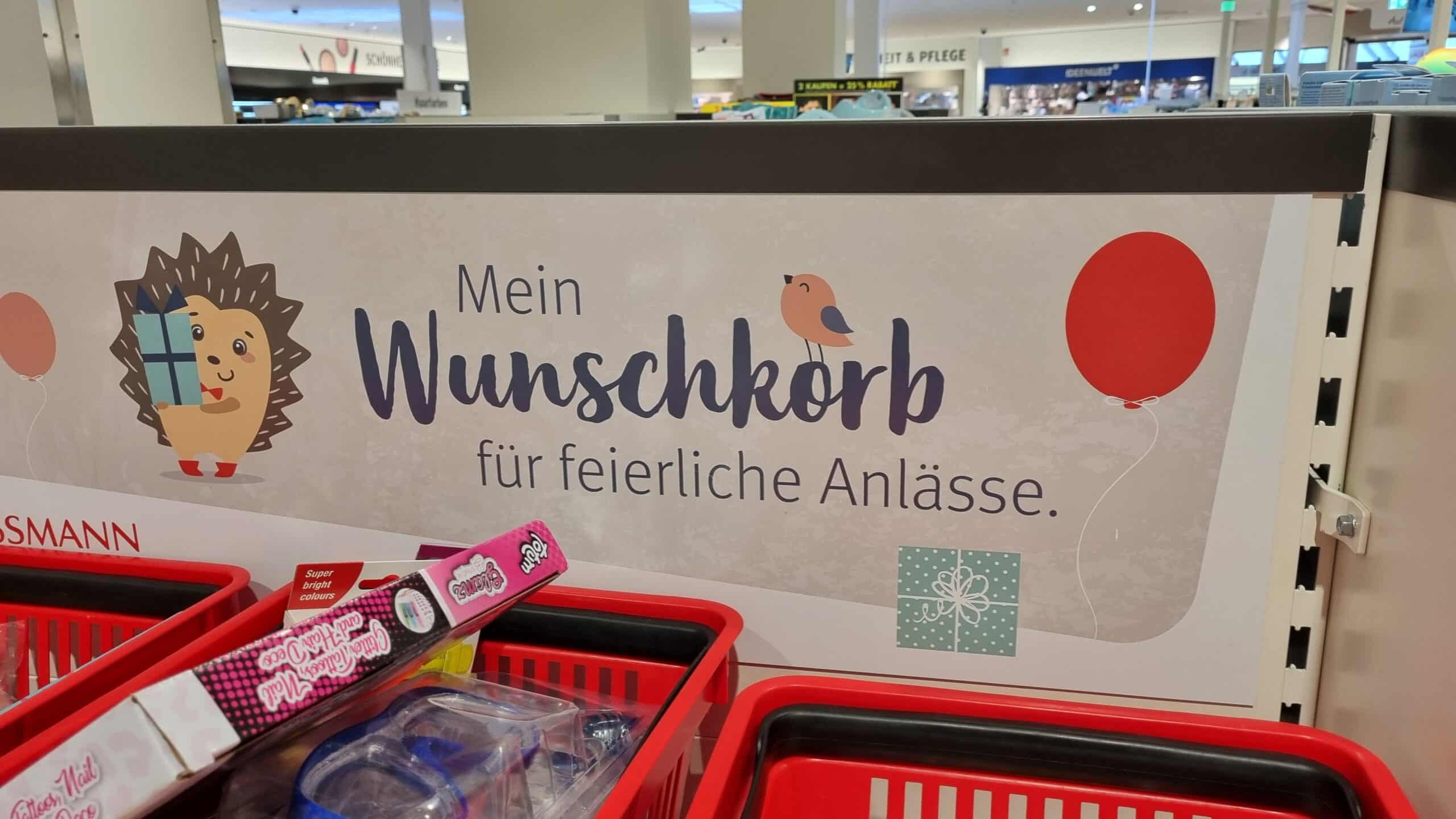 An advertising sign in a Rossmann store promotes the Rossmann wish basket