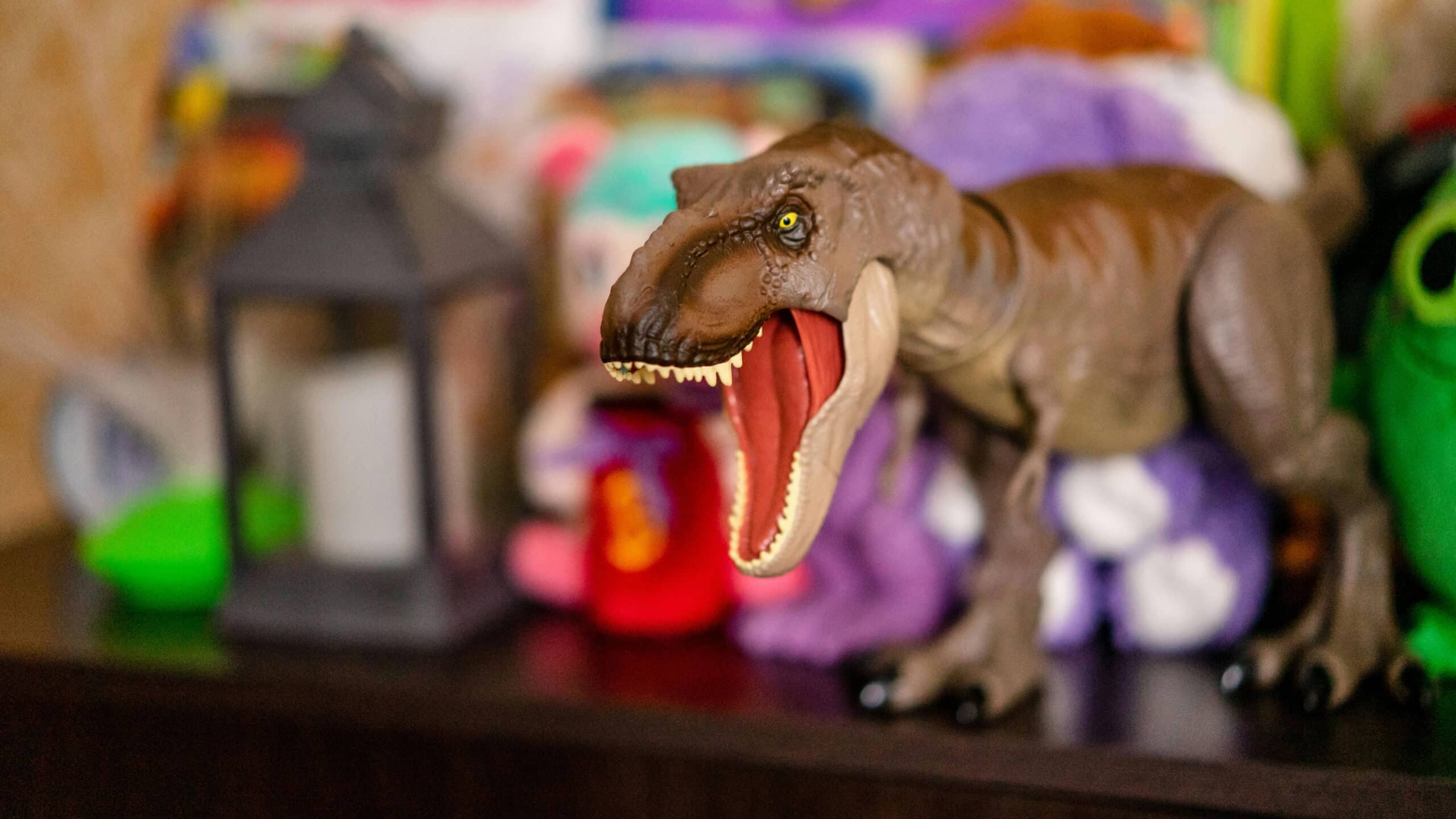 A dinosaur with its mouth open in a child's room.